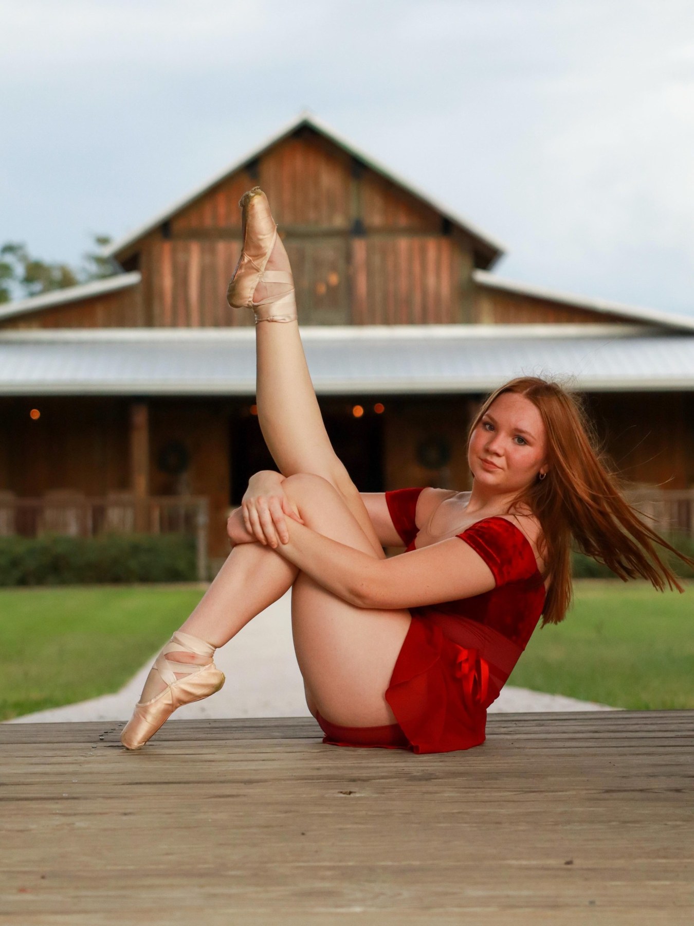 Dancer posing in front of a barn